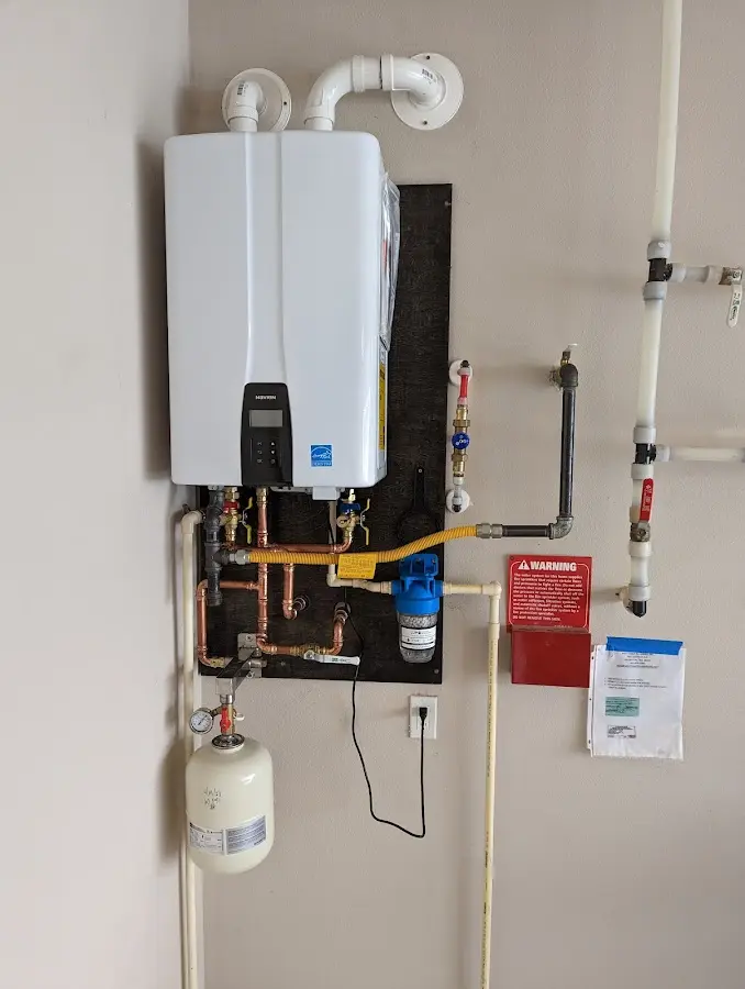 Professional plumber installing copper piping in a Farrell home